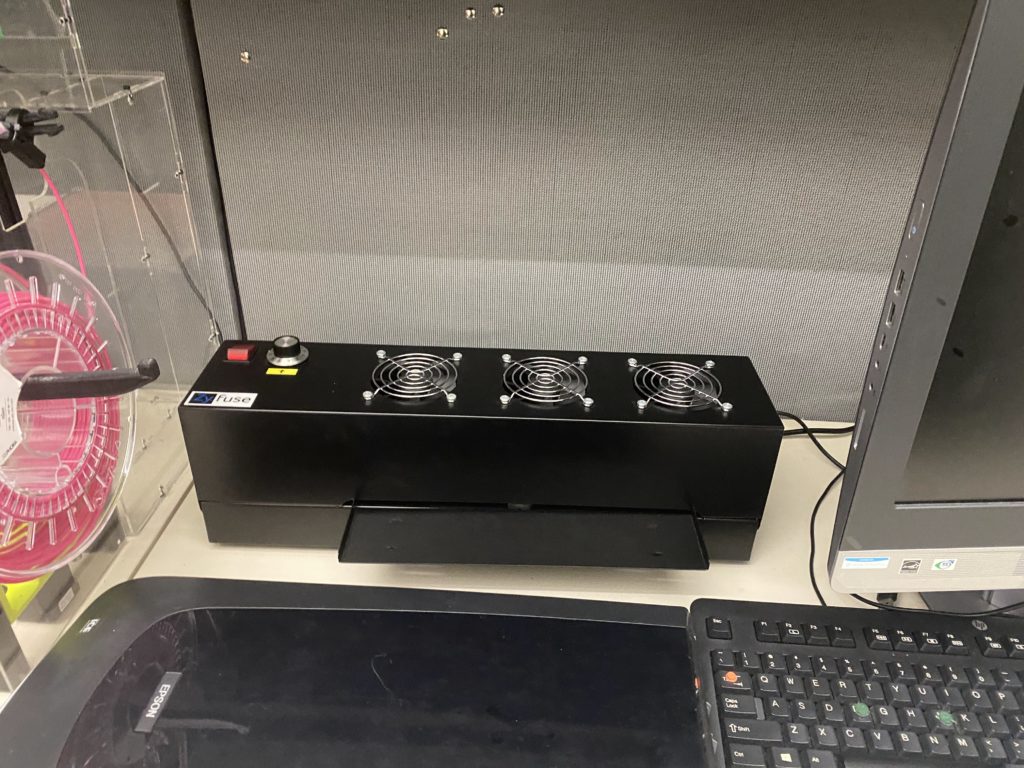 ZY Fuse with three fans, a button, a dial, and a flat plate for printouts