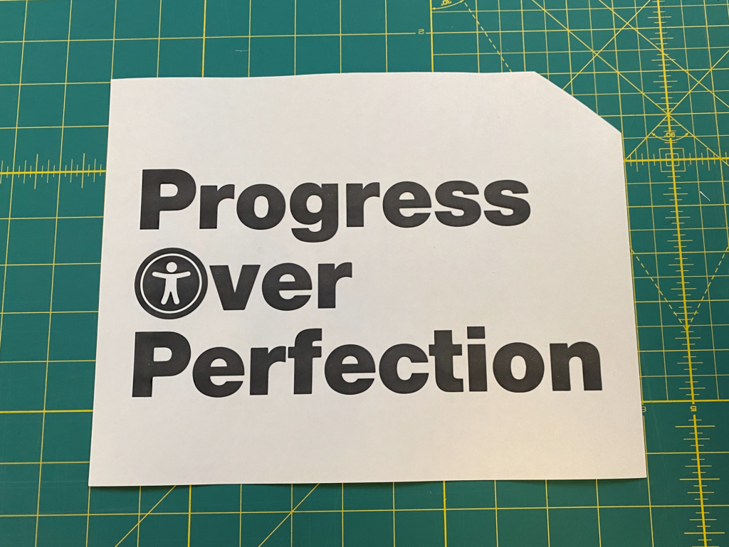 Solid version of "Progress Over Perfection" with the accessibility icon in Over's O and a missing top-right corner.